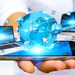 Businessman connecting tech devices